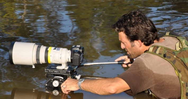 Camera operator uses Canon long lens