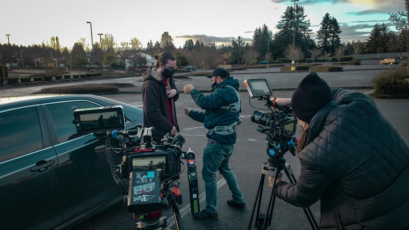 Filmmakers filming on a parking lot for a multi-hour documentary