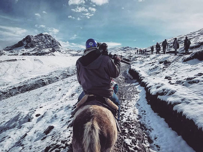Filmmakers filming in subzero temperatures on horseback in rural Peru